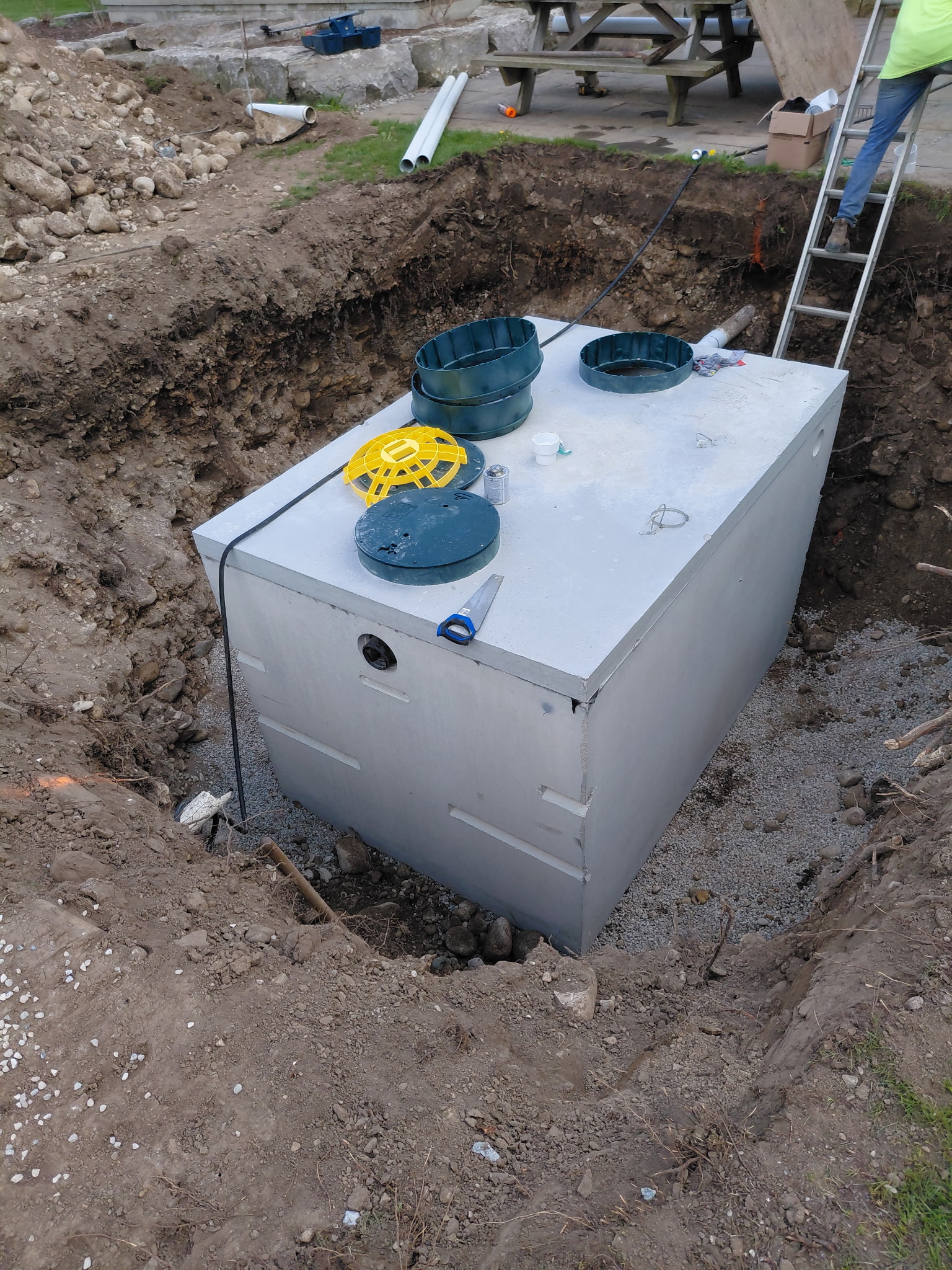 Septic system component being installed in an excavation